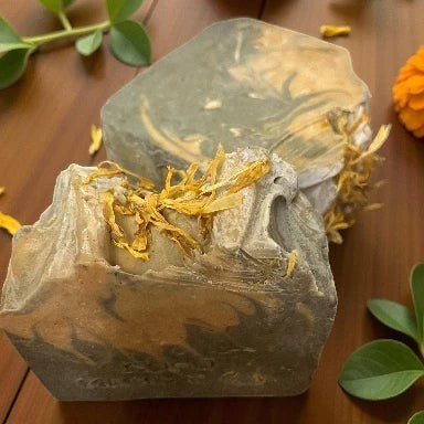 Handcrafted artisanal vegan soap bar made with turmeric, bamboo charcoal, apple cider vinegar, and rosemary essential oil, formulated with organic ingredients including shea butter, avocado oil, and cocoa butter for a natural, chemical-free skincare experience.