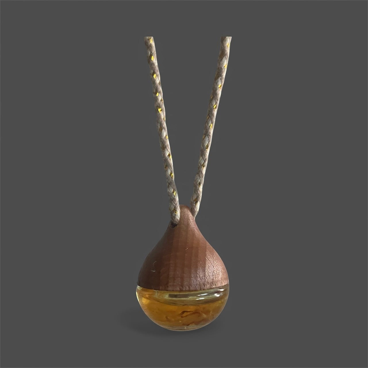 Decorative hanging car diffuser suspended from a rearview mirror, infused with premium essential oils, available in White Tea, Lemon Lavender Mint, Love Spell, and Energy scents for a fresh and calming driving experience.