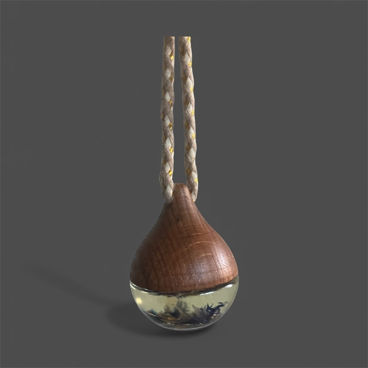 Decorative hanging car diffuser suspended from a rearview mirror, infused with premium essential oils, available in White Tea, Lemon Lavender Mint, Love Spell, and Energy scents for a fresh and calming driving experience.